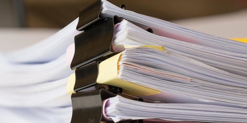 Stack of Paper documents with clip, Pile of unfinished documents on office desk folders. Business papers for Annual Report files, Document is written,presented. Business offices concept.